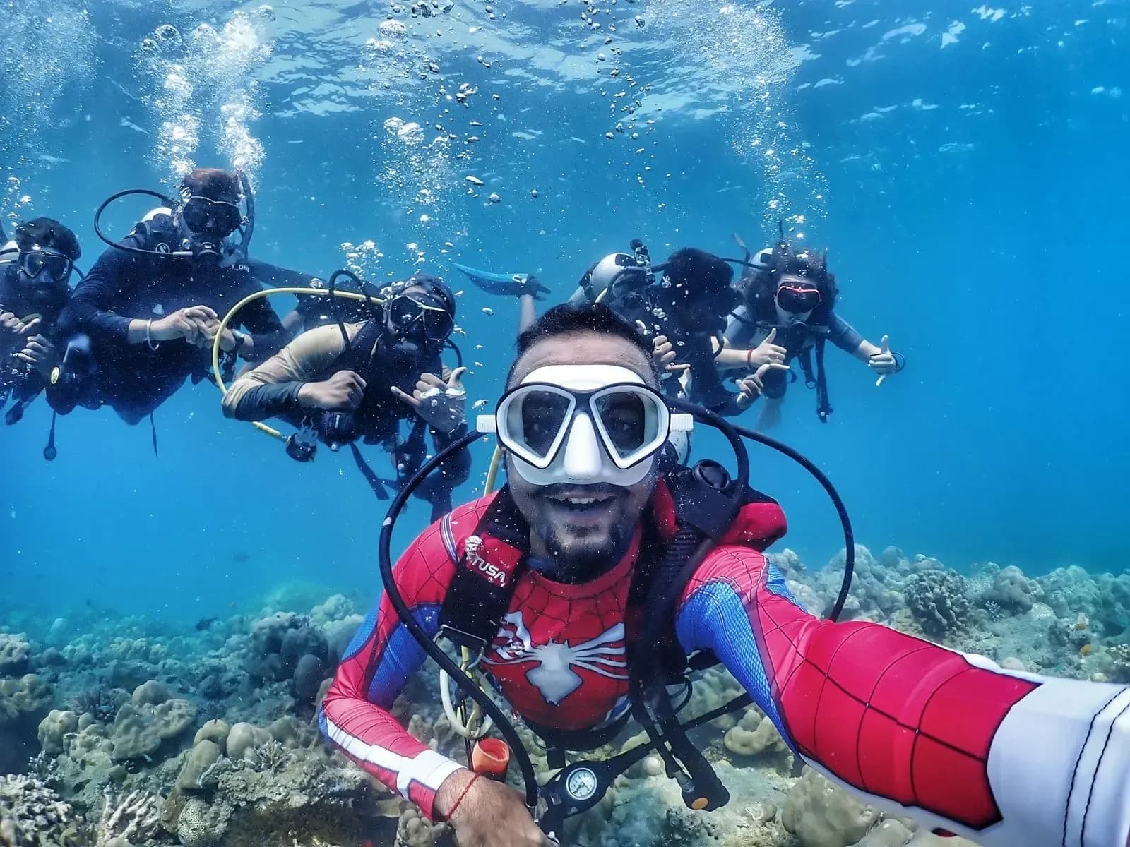 Diver checking a dive computer on a Havelock reef