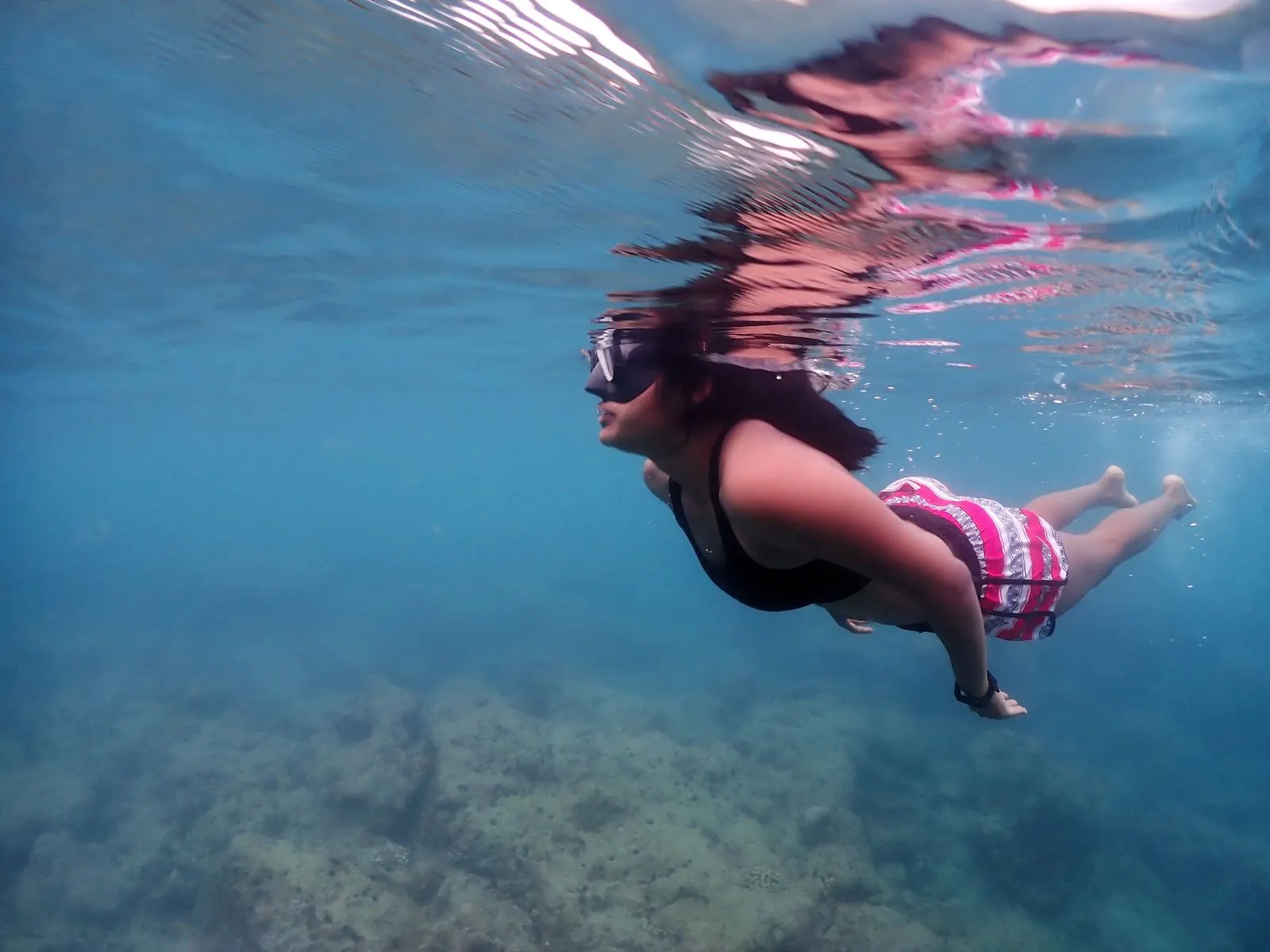 Snorkeler gliding over a shallow Havelock reef on a private boat day